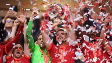 LONDON, ENGLAND - MAY 14: Jordan Henderson of Liverpool lifts The Emirates FA Cup trophy after their sides victory during The FA Cup Final match between Chelsea and Liverpool at Wembley Stadium on May 14, 2022 in London, England. (Photo by Michael Regan - The FA/The FA via Getty Images)