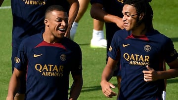 Paris Saint-Germain's French forward Kylian Mbappe (L) and his younger brother Paris Saint-Germain's French Midfielder Ethan Mbappe react as they take part in a training session at the new "campus" of French L1 Paris Saint-Germain (PSG) football club at Poissy, some 30kms west of Paris on July 20, 2023, ahead of the club's Japan tour. (Photo by JULIEN DE ROSA / AFP)