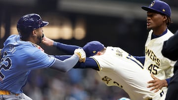 MILWAUKEE, WISCONSIN - APRIL 30: Rhys Hoskins #12 of the Milwaukee Brewers holds back Jose Siri #22 of the Tampa Bay Rays who attempts to go after pitcher Abner Uribe #45 of the Milwaukee Brewers in the eighth inning at American Family Field on April 30, 2024 in Milwaukee, Wisconsin.   John Fisher/Getty Images/AFP (Photo by John Fisher / GETTY IMAGES NORTH AMERICA / Getty Images via AFP)