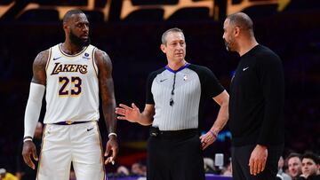 Dec 2, 2023; Los Angeles, California, USA; NBA official separates Los Angeles Lakers forward LeBron James (23) and Houston Rockets head coach Ime Udoka during the second half at Crypto.com Arena. Mandatory Credit: Gary A. Vasquez-USA TODAY Sports