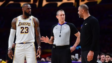 NBA official separates Los Angeles Lakers forward LeBron James (23) and Houston Rockets head coach Ime Udoka during the second half at Crypto.com Arena.