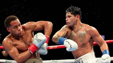 NEW YORK, NEW YORK - APRIL 20: Ryan Garcia (white trunks) punches Devin Haney (gray trunks) during their WBC Super Lightweight title bout at Barclays Center on April 20, 2024 in New York City.   Al Bello/Getty Images/AFP (Photo by AL BELLO / GETTY IMAGES NORTH AMERICA / Getty Images via AFP)