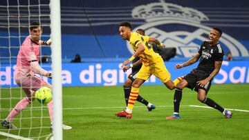 MADRID, SPAIN - MARCH 20: Pierre-Emerick Aubameyang of Barcelona scores his sides first goal past Eder Militao of Real Madrid   during the LaLiga Santander match between Real Madrid CF and FC Barcelona at Estadio Santiago Bernabeu on March 20, 2022 in Mad