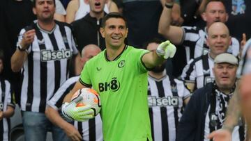 Aston Villa's Argentinian goalkeeper #01 Emiliano Martinez smiles after picking up a yellow card for a professional foul during the English Premier League football match between Newcastle United and Aston Villa at St James' Park in Newcastle-upon-Tyne, north east England on August 12, 2023. (Photo by Ian Hodgson / AFP) / RESTRICTED TO EDITORIAL USE. No use with unauthorized audio, video, data, fixture lists, club/league logos or 'live' services. Online in-match use limited to 120 images. An additional 40 images may be used in extra time. No video emulation. Social media in-match use limited to 120 images. An additional 40 images may be used in extra time. No use in betting publications, games or single club/league/player publications. / 