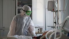 A medical specialist tends to a patient suffering from the coronavirus disease (COVID-19) in the intensive care unit (ICU) of the Clinical Emergency Hospital Number 7, in Volgograd, Russia January 26, 2022. REUTERS/Kirill Braga