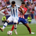 Real Sociedad's Spanish forward #07 Ander Barrenetxea vies with Atletico Madrid's Argentine defender #16 Nahuel Molina during the Spanish league football match between Club Atletico de Madrid and Real Sociedad at the Wanda Metropolitano stadium in Madrid on October 8, 2023. (Photo by Pierre-Philippe MARCOU / AFP)
