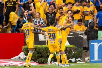 Tigres' Sebastian Cordova (2-R) celebrates with his teammate Andr�-Pierre Gignac (R) after scoring against Santos during their Mexican Apertura football tournament match at Universitario stadium in Monterrey, Mexico, on August 14, 2022. (Photo by Julio Cesar AGUILAR / AFP)