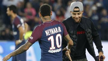 US basketball player Stephen Curry (R) taps hands with Paris Saint-Germain's Brazilian forward Neymar (L) at the start of the French L1 football match between Paris Saint-Germain (PSG) and Saint-Etienne (ASSE) on August 25, 2017, at the Parc des Princes stadium in Paris. / AFP PHOTO / GEOFFROY VAN DER HASSELT