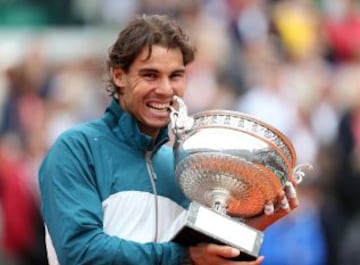 Rafa Nadal muerde el trofeo de Roland Garros 2013 después de derrotar a su compatriota David Ferrer en la final