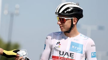 Team UAE Emirates rider Slovenia's Tadej Pogacar wearing the best young's white jersey gives his mask to Team Jumbo rider Slovenia's Primoz Roglic (unseen) prior to the 19th stage of the 107th edition of the Tour de France cycling race, 160