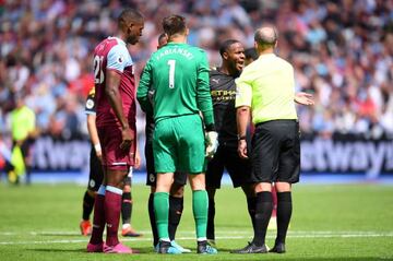 Manchester City players confront referee Mike Dean after a VAR decision disallowed Gabriel Jesus' goal against West Ham United - the first goal to be disallowed by VAR in the Premier League.