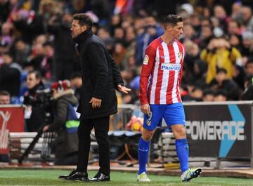 Fernando Torres of Club Atletico de Madrid walks past his manager Diego Simeone after being substituted during the La Liga match between Club Atletico de Madrid and Real Betis