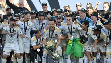 Dec 7, 2024; Carson, California, USA; LA Galaxy defender Maya Yoshida (4) celebrates with the Philip F. Anschutz trophy with teammates on the podium after defeating the New York Red Bulls in the 2024 MLS Cup at Dignity Health Sports Park. Mandatory Credit: Jayne Kamin-Oncea-Imagn Images