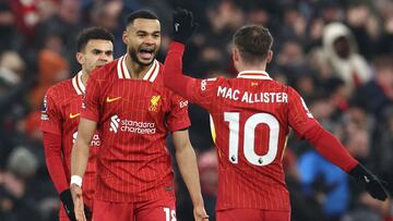 Liverpool's Dutch striker #18 Cody Gakpo (2L) celebrates with teammates after scoring thier firth goal during the English Premier League football match between Liverpool and Manchester United at Anfield in Liverpool, north west England on January 5, 2025. (Photo by Darren Staples / AFP) / RESTRICTED TO EDITORIAL USE. No use with unauthorized audio, video, data, fixture lists, club/league logos or 'live' services. Online in-match use limited to 120 images. An additional 40 images may be used in extra time. No video emulation. Social media in-match use limited to 120 images. An additional 40 images may be used in extra time. No use in betting publications, games or single club/league/player publications. /