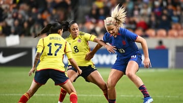 SANDY, UTAH - OCTOBER 26: Lindsey Horan #10 of the United States is marked by  Marcela Restrepo #8 and Carolina Arias #17 of Colombia during the first half of an international friendly match at America First Field on October 26, 2023 in Sandy, Utah. (Photo by Alex Goodlett/USSF/Getty Images for USSF)