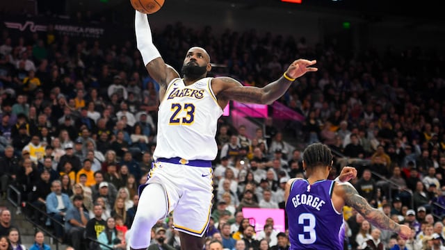 SALT LAKE CITY, UTAH - NOVEMBER 23: LeBron James #23 of the Los Angeles Lakers dunks in front of Keyonte George #3 of the Utah Jazz during the second half of a game at Delta Center on November 23, 2025 in Salt Lake City, Utah. NOTE TO USER: User expressly acknowledges and agrees that, by downloading and or using this photograph, User is consenting to the terms and conditions of the Getty Images License Agreement. Alex Goodlett/Getty Images/AFP (Photo by Alex Goodlett / GETTY IMAGES NORTH AMERICA / Getty Images via AFP)