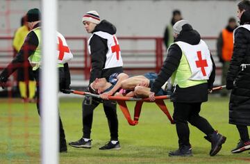 Filipe Luis is carried off on a stretcher during the Lokomotiv game