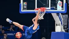 US' Austin Reaves (L) hangs onto the basket during the FIBA Basketball World Cup group C match between US and Greece  at the Mall of Asia Arena in Pasay city, suburban Manila on August 28, 2023. (Photo by SHERWIN VARDELEON / AFP)