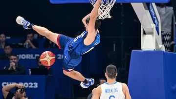 US' Austin Reaves (L) hangs onto the basket during the FIBA Basketball World Cup group C match between US and Greece  at the Mall of Asia Arena in Pasay city, suburban Manila on August 28, 2023. (Photo by SHERWIN VARDELEON / AFP)