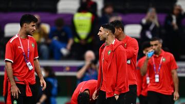 Morocco's goalkeeper #12 Munir El Kajoui (L) and defender #02 Achraf Hakimi walk on the field ahead of the Qatar 2022 World Cup football semi-final match between France and Morocco at the Al-Bayt Stadium in Al Khor, north of Doha on December 14, 2022. (Photo by GABRIEL BOUYS / AFP)