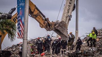 Los equipos de b&uacute;squeda y rescate buscan posibles sobrevivientes entre los escombros del edificio Champlain Towers South de 12 pisos parcialmente derrumbado que se puede ver el 28 de junio de 2021 en Surfside, Florida. 