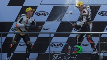 Motorcycling - Moto3 - French Grand Prix - Bugatti Circuit, Le Mans, France - May 20, 2018 Angel Nieto Team Moto3's Albert Arenas celebrates winning the race on the podium as Angel Nieto Team Moto3's Andrea Migno sprays sparkling wine REUTER