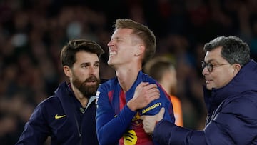 Barcelona's Dani Olmo reacts in pain in his arm after scoring his side's second goal during a Spanish La Liga soccer match between Barcelona and Atletico de Madrid, in Barcelona, Spain, Tuesday, Dec.2, 2025. (AP Photo/Joan Monfort)