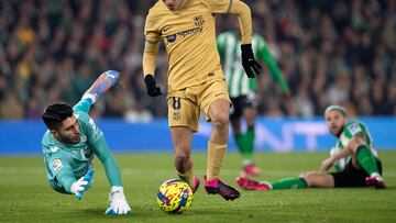 Barcelona's Spanish midfielder Pedri (R) fights for the ball with Barcelona's Spanish goalkeeper Inaki Pena during the Spanish league football match between Real Betis and FC Barcelona at the Benito Villamarin stadium in Seville on February 1, 2023. (Photo by JORGE GUERRERO / AFP)
