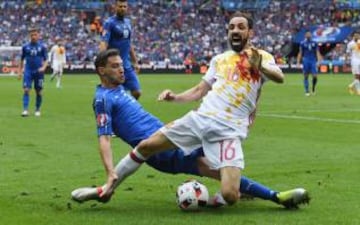 Juanfran of Spain is tackled by Italy's full back Mattia De Sciglio who although starting the tournament on the bench proved to be very solid against the defending champions.