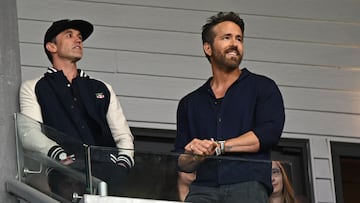 US actor and Wrexham owner Rob McElhenney (L) and US actor and Wrexham owner Ryan Reynolds (R) await kick-off in the English National League football match between Wrexham and Boreham Wood at the Racecourse Ground Stadium in Wrexham, north Wales, on April 22, 2023.