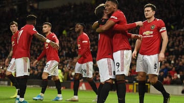 Manchester United's French striker Anthony Martial (2R) celebrates scoring their third goal during the English Premier League football match between Manchester United and Norwich City at Old Trafford in Manchester