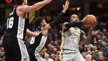 Feb 25, 2018; Cleveland, OH, USA; San Antonio Spurs center Pau Gasol (16) and guard Patty Mills (8) defend Cleveland Cavaliers forward LeBron James (23) during the first half at Quicken Loans Arena. Mandatory Credit: Ken Blaze-USA TODAY Sports
