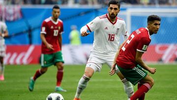 Iran&#039;s forward Alireza Jahanbakhsh challenges Morocco&#039;s defender Achraf Hakimi (R) during the Russia 2018 World Cup Group B football match between Morocco and Iran at the Saint Petersburg Stadium in Saint Petersburg on June 15, 2018. / AFP PHOTO