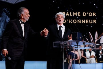 Francis Ford Coppola holds hands with George Lucas, who was presented with an honorary Palme d'Or award during the closing ceremony of the 77th Cannes Film Festival in Cannes, France, May 25, 2024. REUTERS/Clodagh Kilcoyne