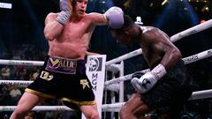 LAS VEGAS, NEVADA - SEPTEMBER 30: Saul "Canelo" Alvarez of Mexico (purple/gold trunks) trades punches with�Jermell Charlo (black trunks)�during their�super middleweight title fight at T-Mobile Arena on September 30, 2023 in Las Vegas, Nevada.   Sarah Stier/Getty Images/AFP (Photo by Sarah Stier / GETTY IMAGES NORTH AMERICA / Getty Images via AFP)