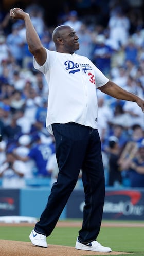 LOS ANGELES, CALIFORNIA - OCTOBER 29: Magic Johnson throws out the ceremonial first pitch before game five of the 2025 World Series between the Toronto Blue Jays and the Los Angeles Dodgers at Dodger Stadium on October 29, 2025 in Los Angeles, California. Ronald Martinez/Getty Images/AFP (Photo by RONALD MARTINEZ / GETTY IMAGES NORTH AMERICA / Getty Images via AFP)