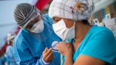 A nurse applies a dose of the vaccine developed by Sinopharm of China against COVID-19 during a health workers vaccination campaign amid the novel coronavirus pandemic, in Lima on February 19, 2021. (Photo by Ernesto BENAVIDES / AFP)