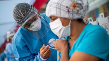 A nurse applies a dose of the vaccine developed by Sinopharm of China against COVID-19 during a health workers vaccination campaign amid the novel coronavirus pandemic, in Lima on February 19, 2021. (Photo by Ernesto BENAVIDES / AFP)