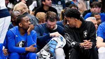 Apr 7, 2023; Dallas, Texas, USA; Dallas Mavericks guard McKinley Wright IV (23) and guard Luka Doncic (77) and forward Christian Wood (35) sit on the team bench during the first half against the Chicago Bulls at the American Airlines Center. Mandatory Credit: Jerome Miron-USA TODAY Sports