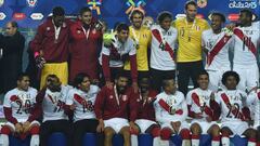 Peruvian players celebrate on the podium at the end of their Copa America third place football match against Paraguay in Concepcion, Chile on July 3, 2015. Peru won 2-0.  AFP PHOTO / LUIS ACOSTA