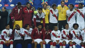 Peruvian players celebrate on the podium at the end of their Copa America third place football match against Paraguay in Concepcion, Chile on July 3, 2015. Peru won 2-0. AFP PHOTO / LUIS ACOSTA
