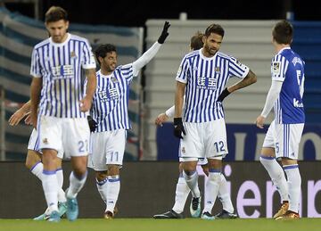 Real Sociedad's Mexican forward Carlos Vela (2L) celebrates after scoring his team's third goal during the Spanish league football match Real Sociedad against Sevilla FC at the Anoeta stadium in San Sebastian on December 20, 2017. / AFP PHOTO / ANDER GILLENEA