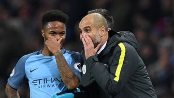 Manchester City&#039;s Spanish manager Pep Guardiola (R) talks to Manchester City&#039;s English midfielder Raheem Sterling 