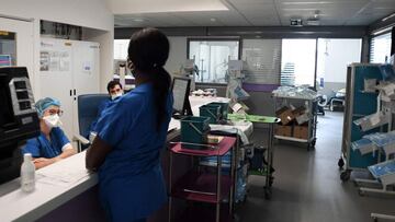 Medical staff members work at a desk in the intensive care unit of the Henri Mondor Hospital in Creteil, near Paris, on July 22, 2021. (Photo by ALAIN JOCARD / AFP)