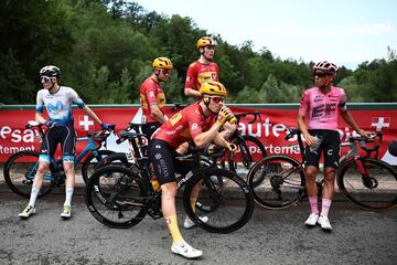 Ciclistas del pelot¨®n espectantes tras la detenci¨®n de la carrera debido al accidente masivo en el que cayeron al suelo m¨¢s de 30 ciclistas.