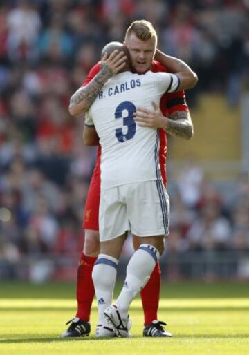 John Arne Riise hugs Real Madrid's Roberto Carlos