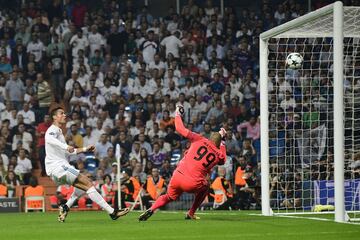 Real Madrid's forward from Portugal Cristiano Ronaldo (L) scores a goal to APOEL Nicosia's goalkeeper from the Netherlands Boy Waterman that will be cancelled by line referee during the UEFA Champions League football match