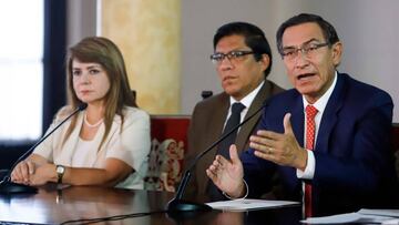 Handout picture released by the Peruvian Presidency showing President MartxEDn Vizcarra (L) next to his Minister of Health, Elizabeth Hinostroza (L) and Premier Vicente Zeballos during an unscheduled televised press conference reporting on the measures an