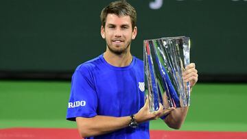 Cameron Norrie of Great Britain poses with the winner's trophy after victory over Nikoloz Basilashvili of Georgia in their men's final match at the Indian Wells tennis tournament on October 17, 2021 in Indian Wells, California. - Cameron Norrie's breakthrough season reached a high point in the California desert on Sunday with a 3-6, 6-4, 6-1 win over Nikoloz Basilashvili to become the first Briton to win the ATP Indian Wells title.
Norrie rallied from a set down to earn his career best 47th win of the season and is the first player from Britain to lift the trophy, achieving what former finalists Andy Murray, Tim Henman and Greg Rusedski failed to do. (Photo by Frederic J. BROWN / AFP)