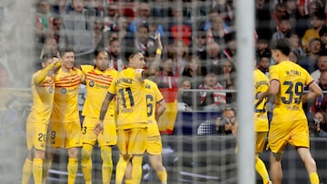 Barcelona's Polish forward #09 Robert Lewandowski (2L) celebrates scoring his team's second goal during the Spanish league football match between Club Atletico de Madrid and FC Barcelona at the Metropolitano stadium in Madrid on March 17, 2024. (Photo by OSCAR DEL POZO / AFP)